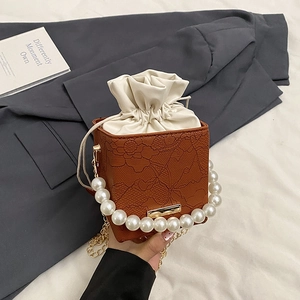 Retro caramel cylinder bucket bag with pearl handle and lace embossed texture