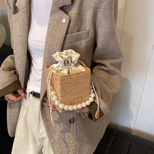 Elegant beige lace bucket bag with pearl handle and drawstring lining for women