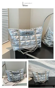 Close-up of silver quilted handbag featuring golden chain strap and deer charm detail