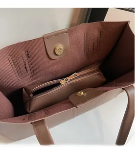 Detail of large tote bag interior showing magnetic clasp and matching zipper pouch