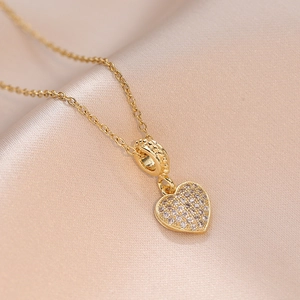 Minimalist heart pendant necklace with zircon pavé on a luxurious champagne satin backdrop