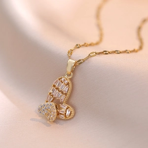 Elegant gold double-layer necklace with rotating butterfly heart pendant and zircons