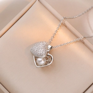 Elegant silver heart necklace with zircon crystals and pearl in a champagne jewelry box