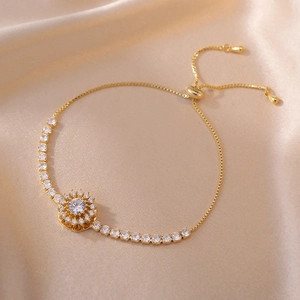Golden sunflower zircon bracelet with adjustable slider chain on elegant satin background