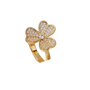 Golden clover open ring with sparkling zircon heart-shaped petals on white background