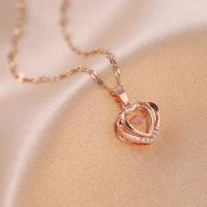 Rose gold heart necklace with dancing gemstone on champagne satin background