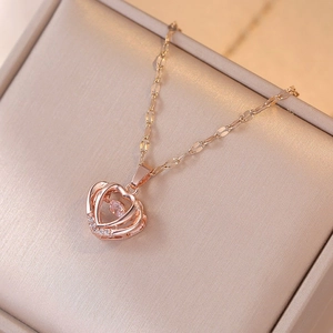 Rose gold beating heart necklace with teardrop stone and crystal pavé on jewelry box