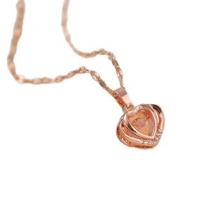 Rose gold heart pendant necklace with pink gemstone and crystals on a rope chain