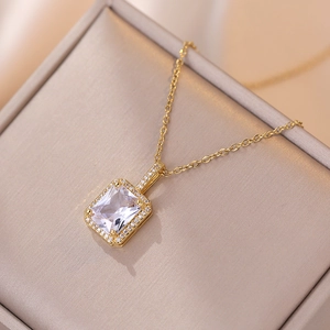 Golden pendant necklace with rectangular zircon stone on champagne jewelry display box