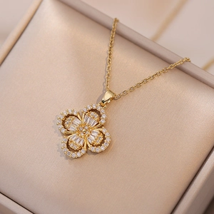 Elegant gold four-leaf flower pendant necklace with zircon crystals in a luxury gift box