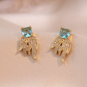 Luxe gold-plated drop earrings featuring square blue gemstones and zircon wing accents