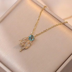 Elegant gold necklace with square blue stone and crystal-encrusted feather pendants