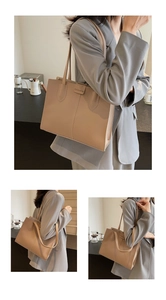 Detail of light brown leather tote bag showing FASHION logo and slim shoulder strap