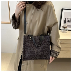 Brown leopard print tote bag with black handles and adjustable strap for women
