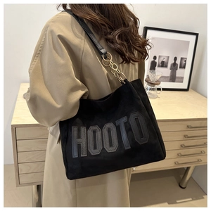 Large black suede tote bag with HOOTO logo and gold chain strap on shoulder