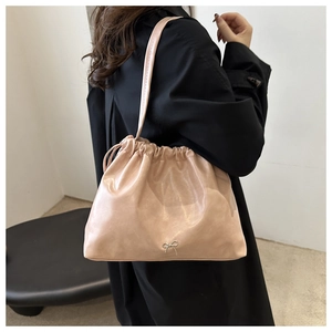 Pink soft leather shoulder bucket bag detail showing exquisite drawstring closure and bow.