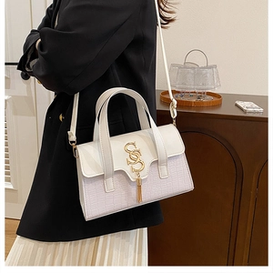 Minimalist lavender croc-embossed patchwork handbag with gold metal fringe detail and strap