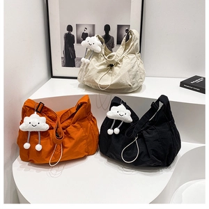 Lightweight nylon crossbody bag with pleated texture and cute plush charm in three colors