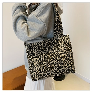 Detailed view of leopard print canvas tote bag with large capacity and shoulder straps