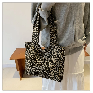 Close-up of leopard print tote bag paired with a gray hoodie for a casual trendy look