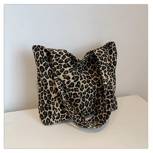 Detailed view of large canvas tote bag with classic leopard print and wide shoulder straps