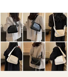 Detailoverzicht van stijlvolle crossbodytassen in zwart en crème met brede schouderriem