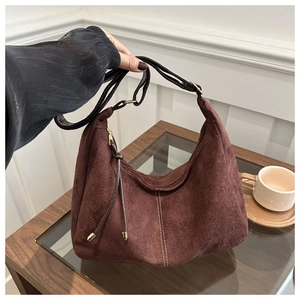 Detail of vintage dark brown frosted suede shoulder bag with white contrast stitching