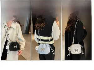 Detailed view of bucket bags with butterfly charms in black, blue, and white colors