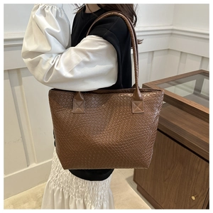 Detailed view of dark brown woven texture on large capacity vintage tote bag for women