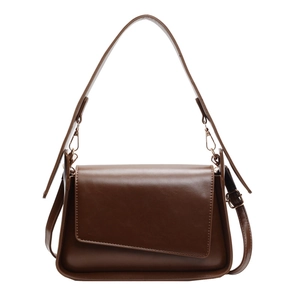 Brown vintage leather shoulder bag with asymmetric flap and adjustable gold metal straps