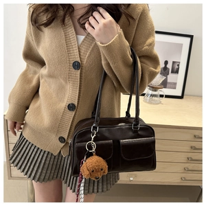 Détail du sac à bandoulière rétro marron foncé avec poches et charm en peluche