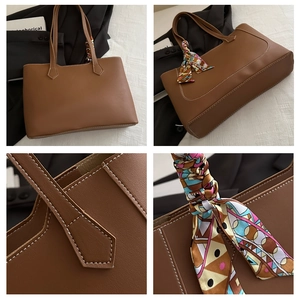 Detail of brown faux leather tote bag with white stitching and decorative silk scarf