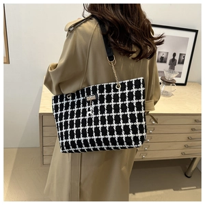 Classic black and white checkered tote bag with gold chain strap and deer charm detail