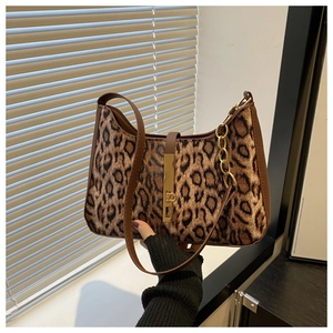 Détail du sac sous le bras à imprimé léopard avec fermoir doré et bordures en cuir brun