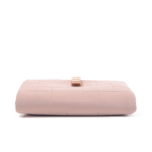 Side view of pink leather wallet with geometric stitching and rose gold metal clasp