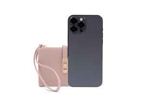 Close-up of pink pebbled leather mini wallet with wristlet next to a phone for size