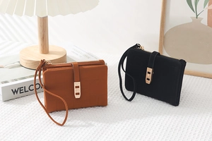 Detail of checkered PU leather wallets with gold hardware and wrist straps
