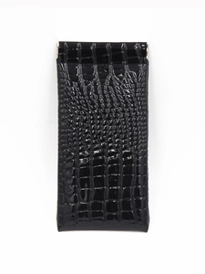 Detail of black crocodile texture glasses pouch with glossy faux leather finish