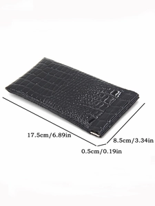 Macro view of black crocodile pattern leather glasses pouch with metal squeeze closure