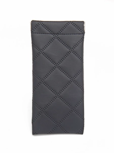 Close-up of black quilted leather glasses pouch with automatic metal spring closure