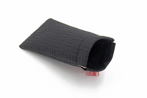 Detailed close-up of a black textured storage pouch with a geometric embossed pattern