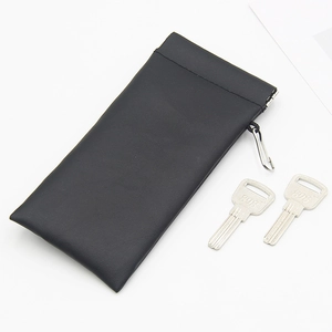 Portable leather sunglass pouch with squeeze closure and metal hook for keys and storage