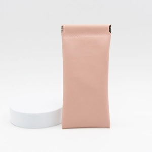 Detail of pink PU leather sunglasses pouch with squeeze self-closing metal spring top