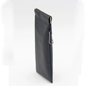 Detail view of black leather sunglasses pouch with metal spring closure and carabiner hook