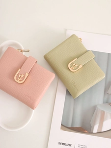 Detailed macro view of the gold tulip buckle and textured PU leather on a small zip wallet
