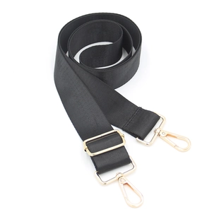 Close-up of adjustable black woven strap featuring premium gold lobster clasps and buckles