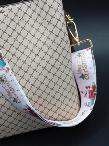 Detailed close-up of wide Christmas strap with Merry Christmas text and gold hardware