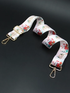 Detail of Christmas print bag strap with golden metal swivel hooks and Merry Christmas text