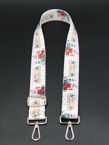 Close-up of Merry Christmas printed strap with gold lobster claws and adjustable buckles