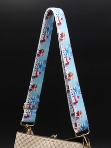 Detail of wide sky blue Christmas strap with snowmen and gold metal hardware